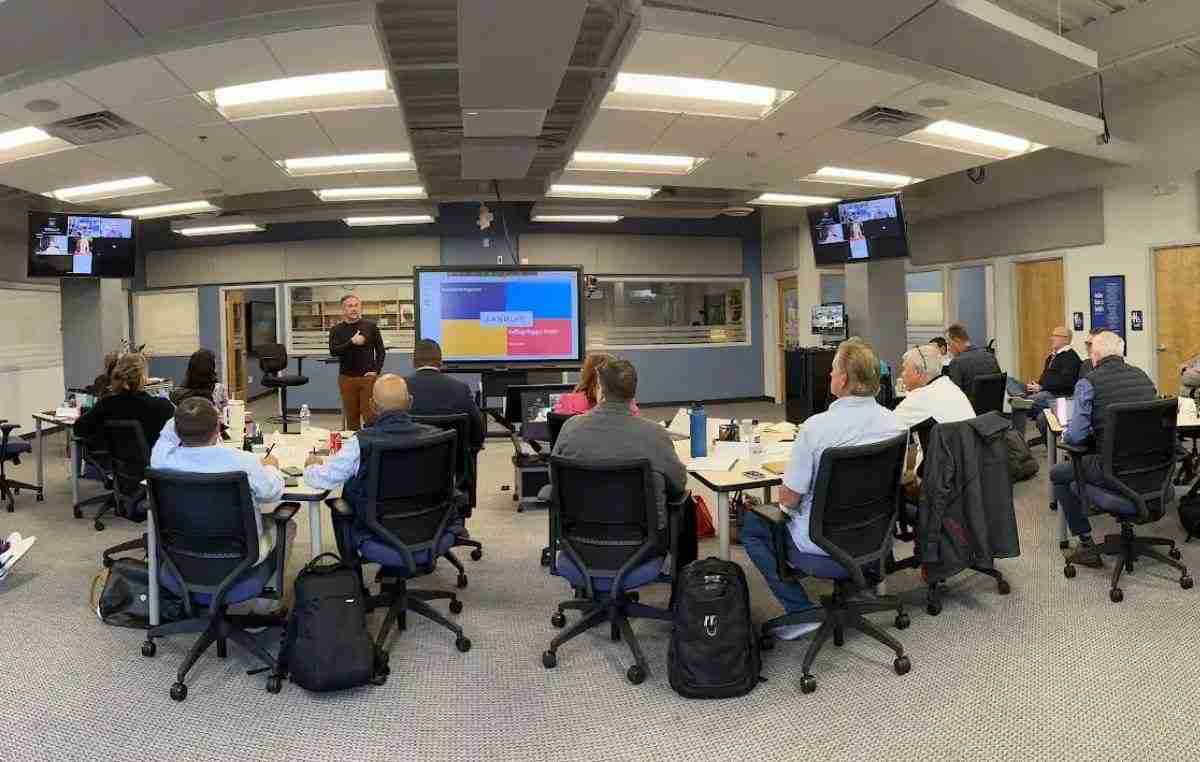 B2B corporate training workshop with franchisees learning sales strategies from a Sandler® instructor