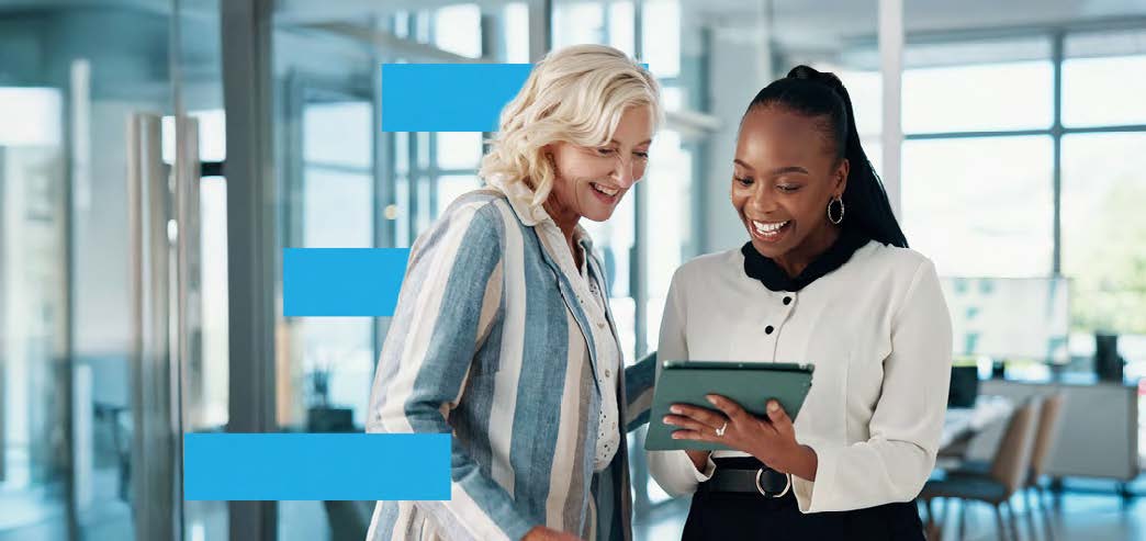 two businesswomen looking at a tablet together
