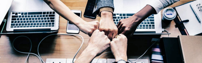 Five people fist-bumping